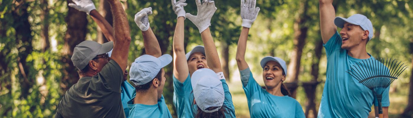 Group of volunteers giving each other high fives.